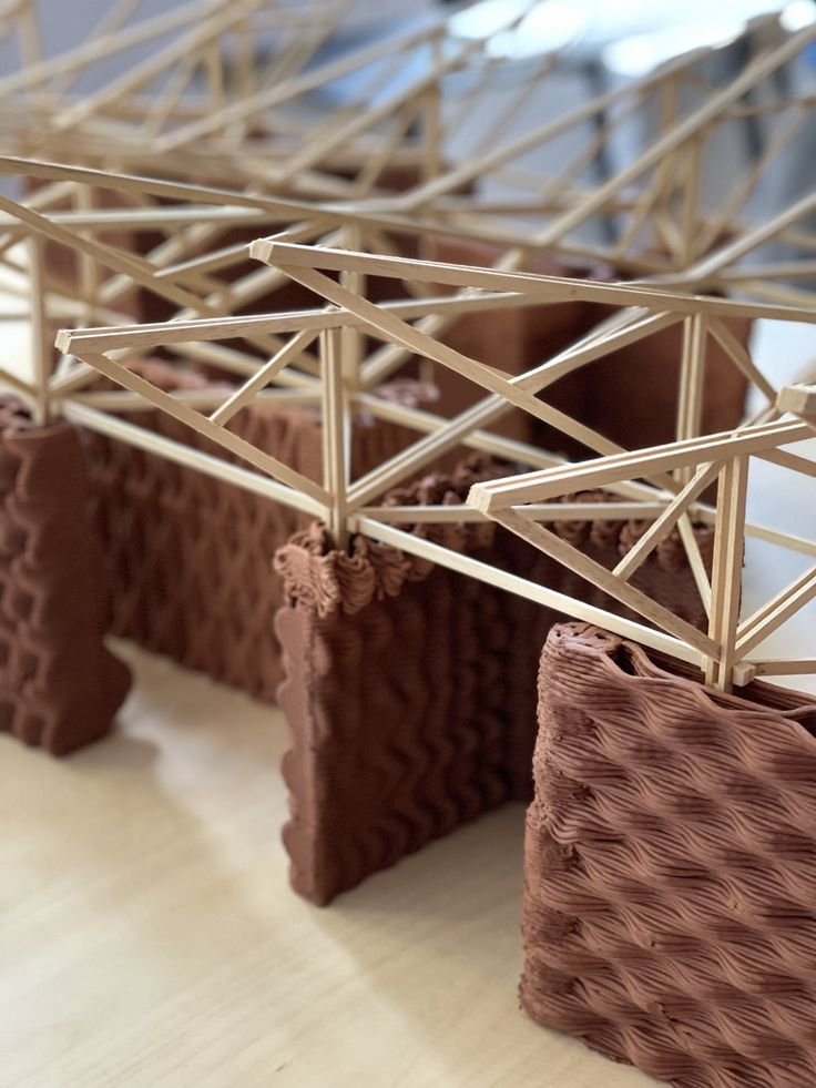 10 راهکار طلایی برای ساخت مدلهای مفهومی معماری 8 ماکت پل خرپایی ساخته شده از چوبهای نازک، با پایههای قهوهای رنگ و بافت موجدار.